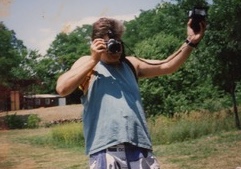 Ross holding a camera and a light meter