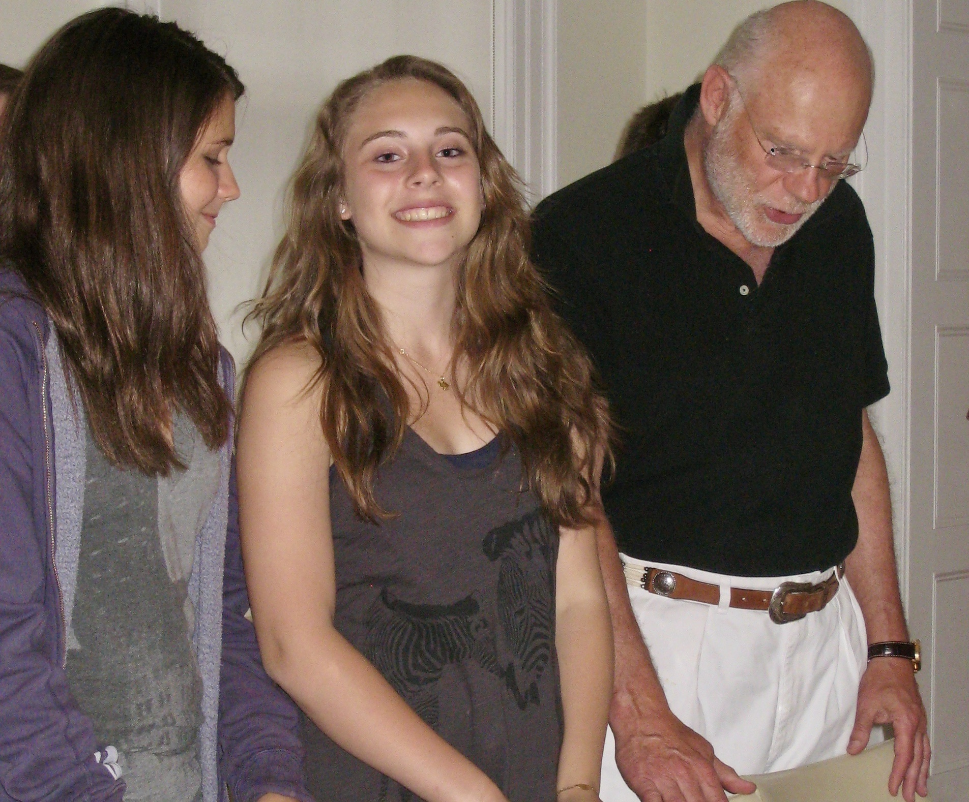 Julia, Claire, and Francis smiling at a birthday celebration