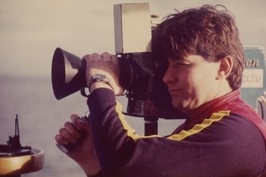 Ross operating a movie camera on set