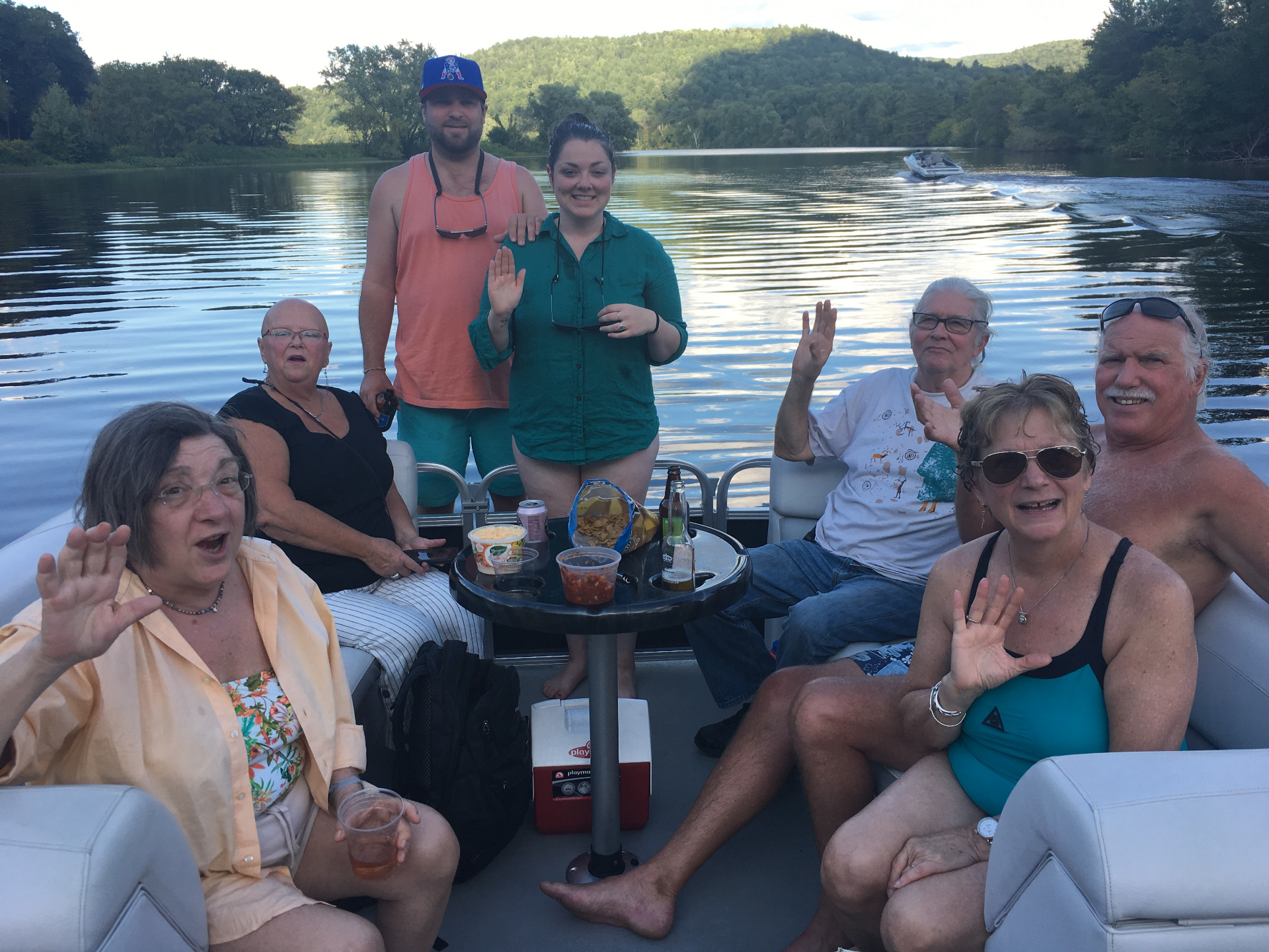 Family gathered on a pontoon boat on the river