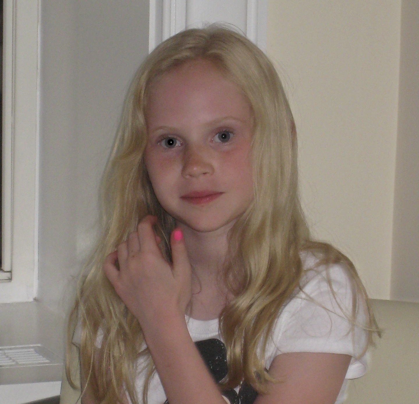 Portrait of a young Claire with long blonde hair